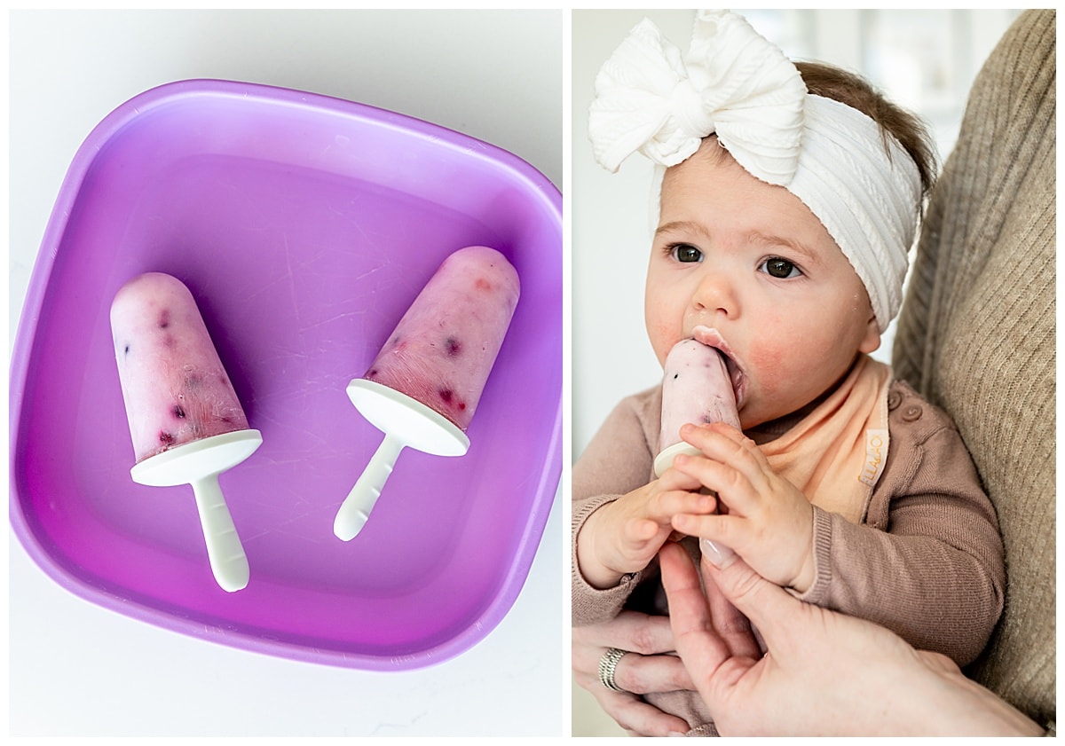 Yogurt popsicles with berries. A baby girl is eating the popsicle.