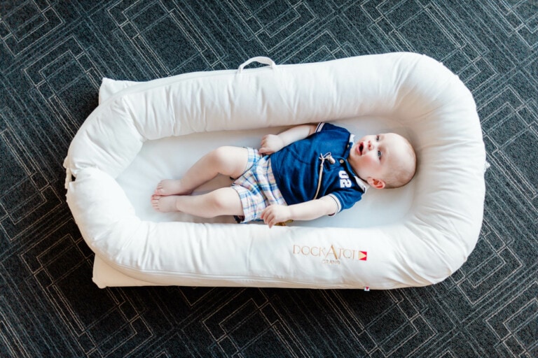 Baby boy laying in a dockatot.